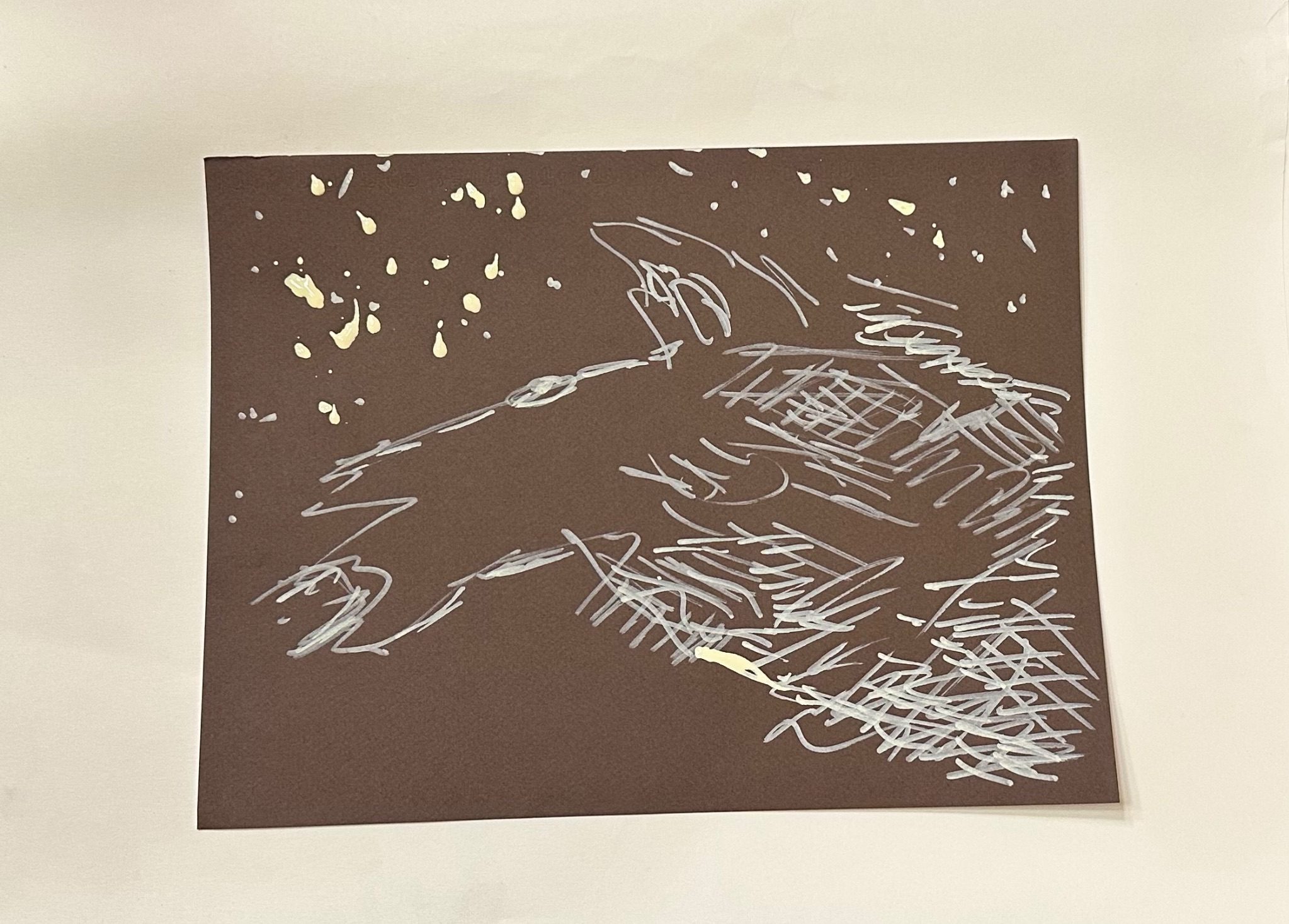 Markings in cream on a brown background, suggestive of the head of a woolf but done blindfolded