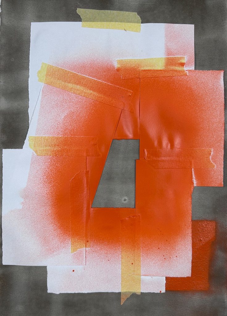 A collage of orange spray painted paper on a cement background