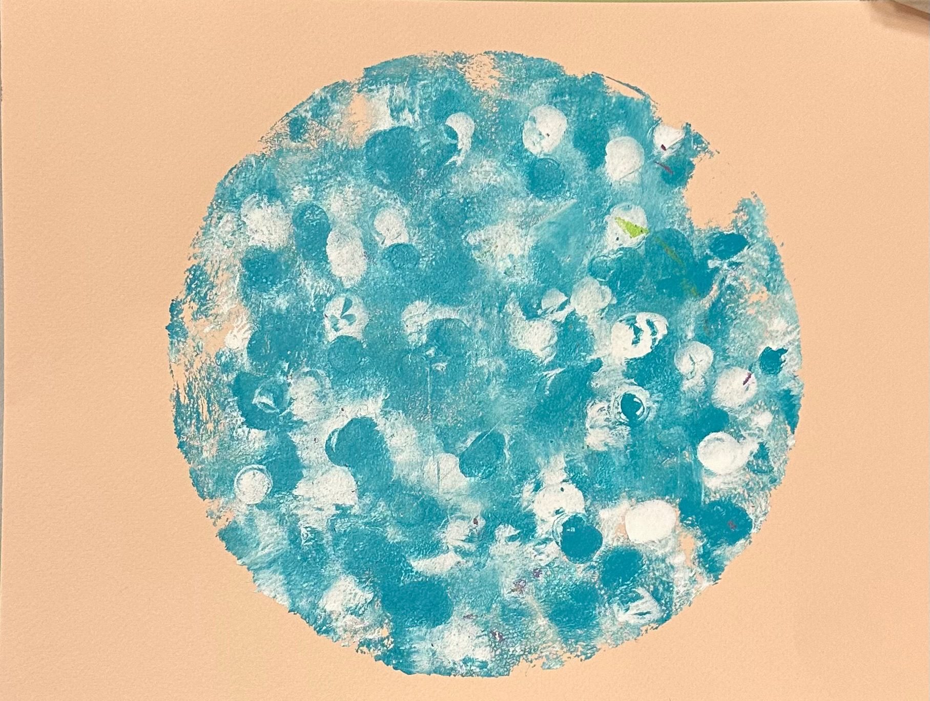 A gelli print in shape of a moon in tones of turquoise