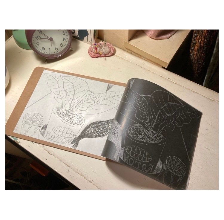 Still life drawing with plant and cup. Carbon paper and tracing paper on a table top. A4