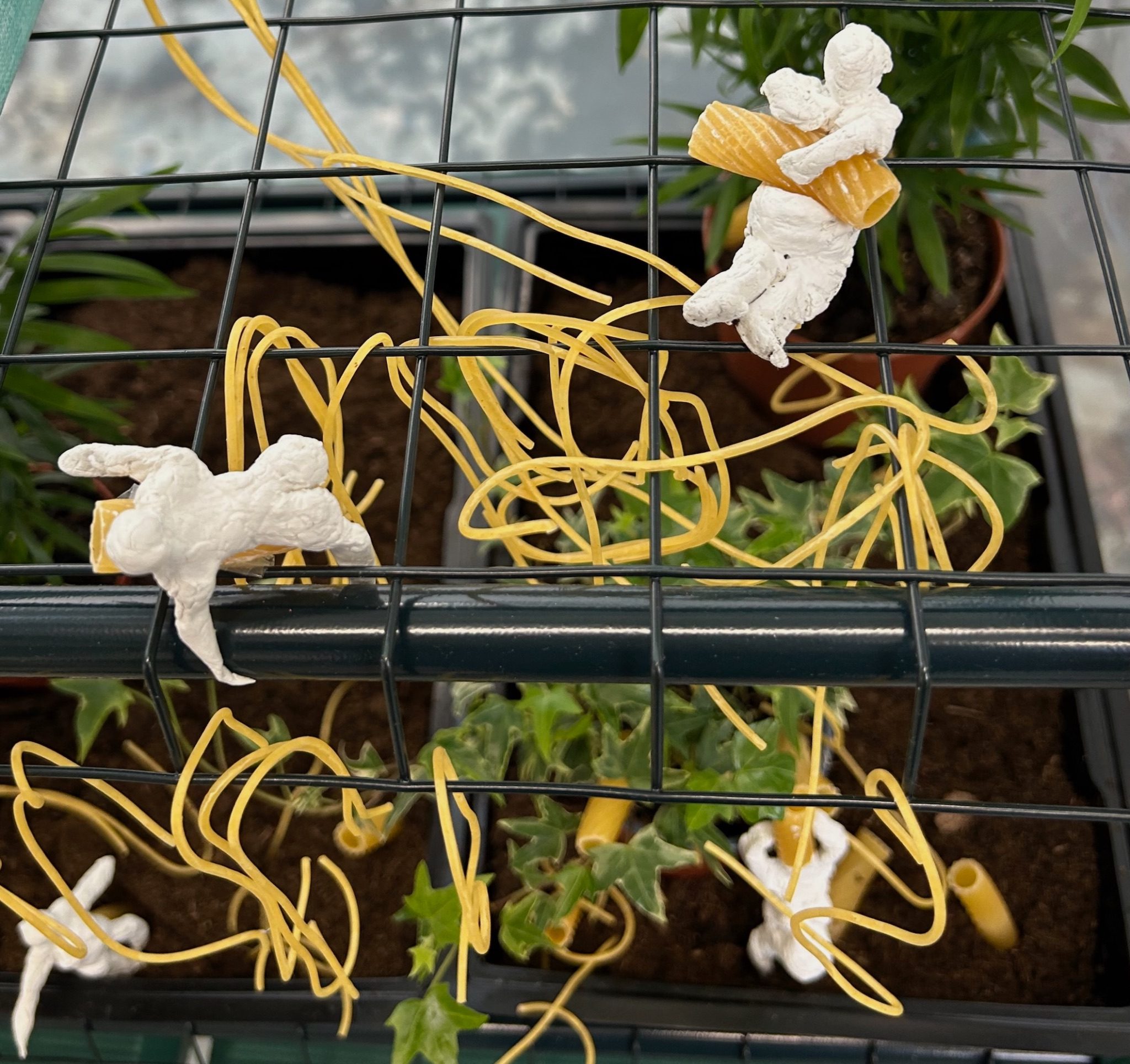 Detail from the Pastascopic animation - clay figures hugging hmaccheroni pasta and spaghetti