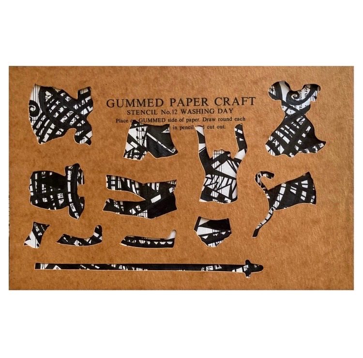 Stencil of clothes with drawn patterns in ink on music score