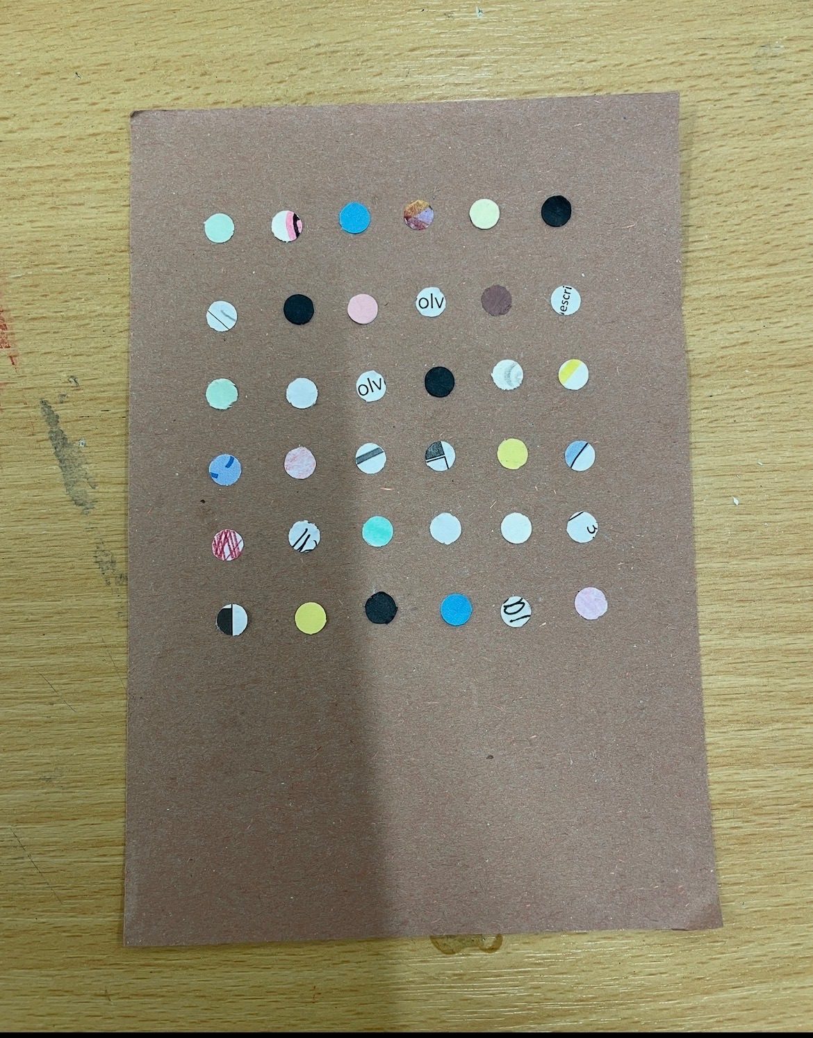 Colourful dots on brown card