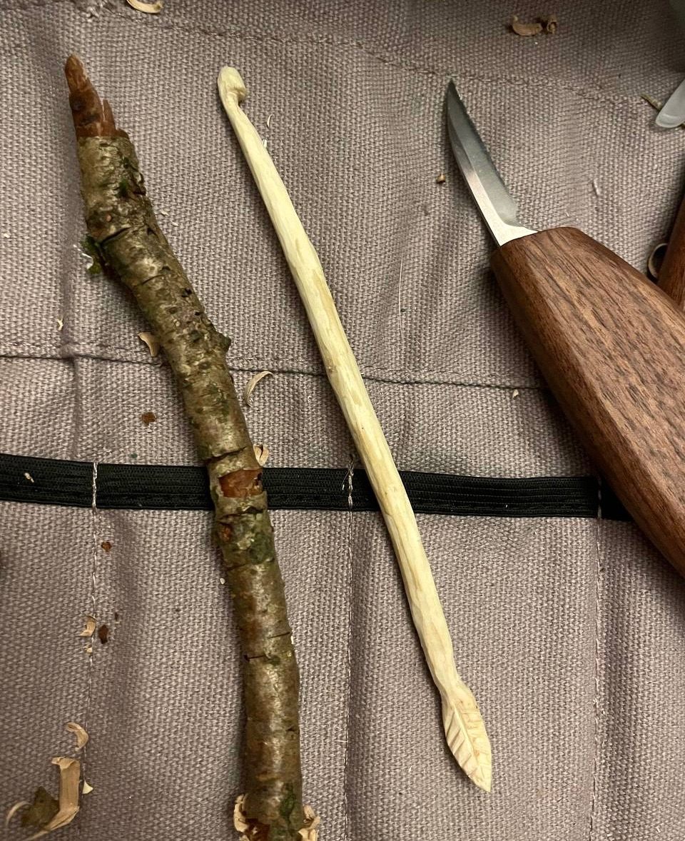 Whittled crochet hook with leaf design at the bottom