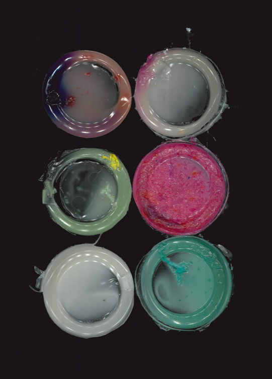 Colourful dried up glue from glue pots