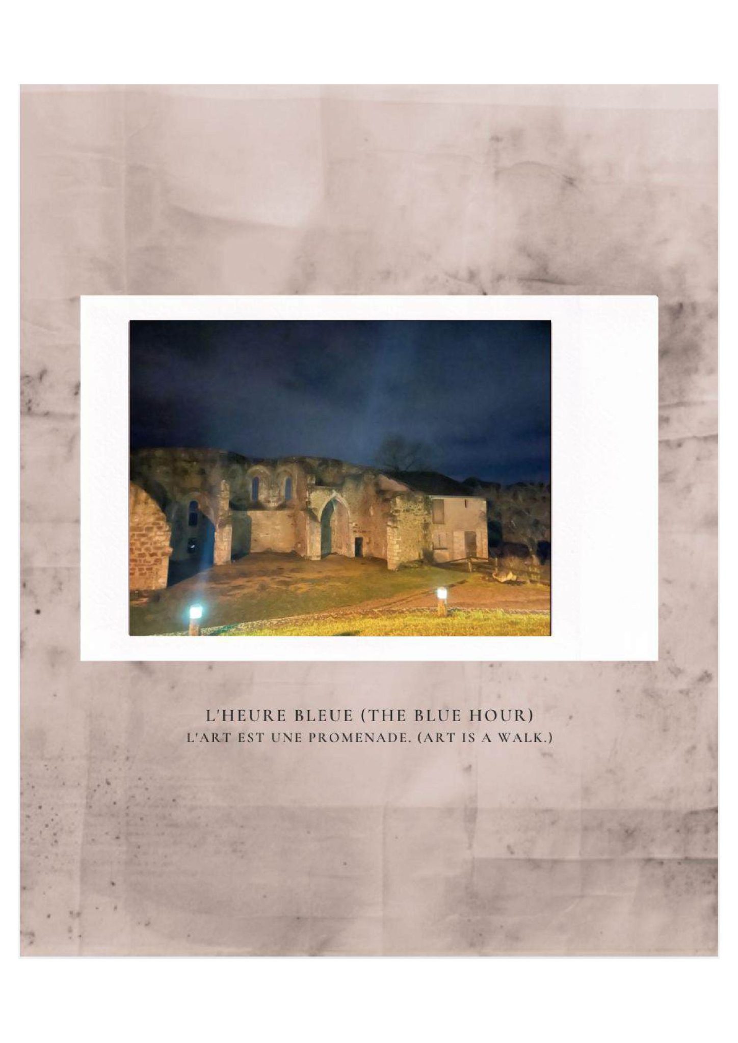A central photograph captures the soft, painterly glow of ancient stone ruins illuminated by warm streetlights against a deep navy sky, set upon a textured, dusty-pink paper background. The bilingual caption titled 