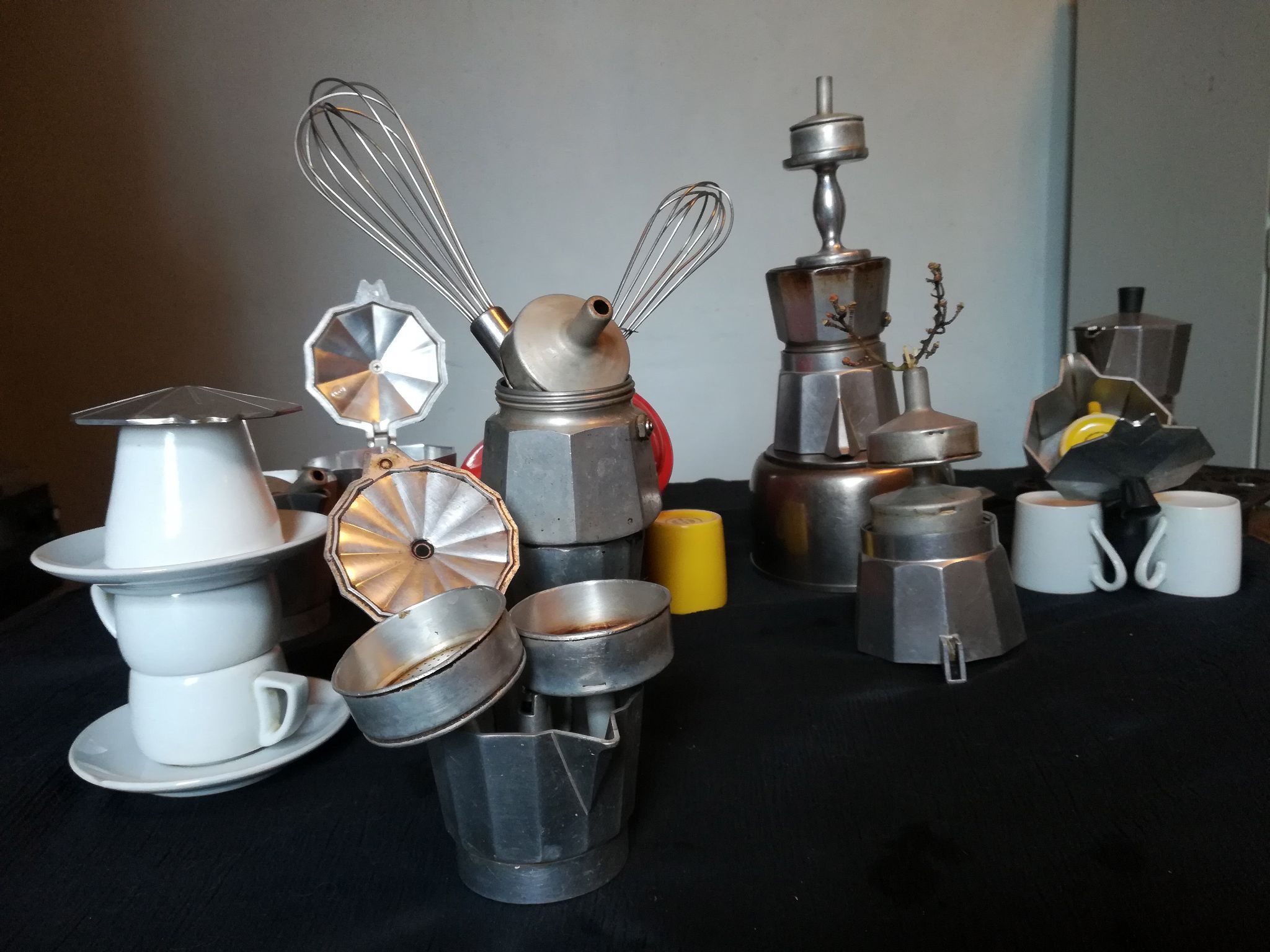 Many espresso coffee pot parts , espresso cups and coffee apparatus made into sculpture figures