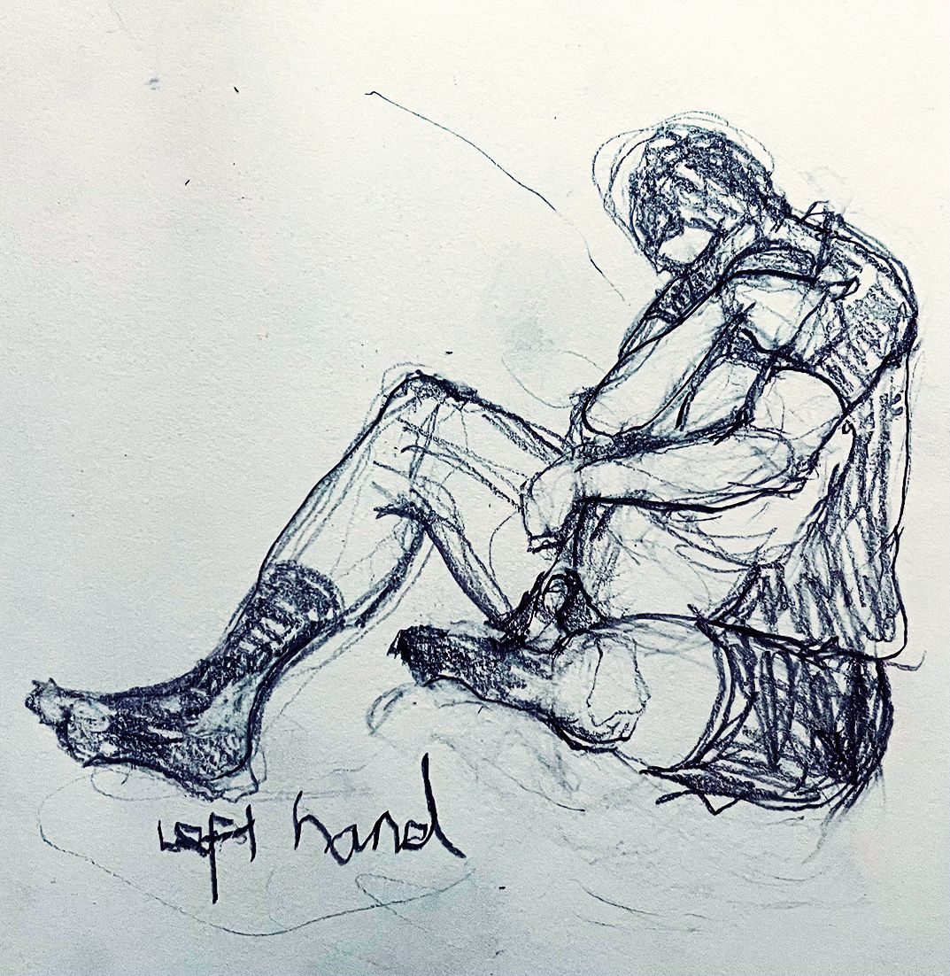 Drawing of a father and child in my sketchbook done with my left hand.