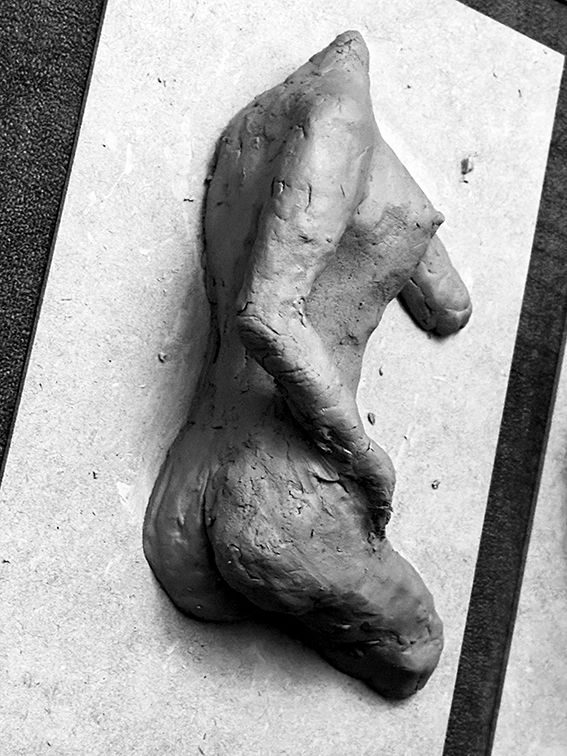 Sculpture of female torso in red clay