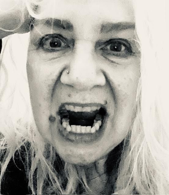 [black and white photo of a face, long white hair, eyes wide, mouth open, shouting]