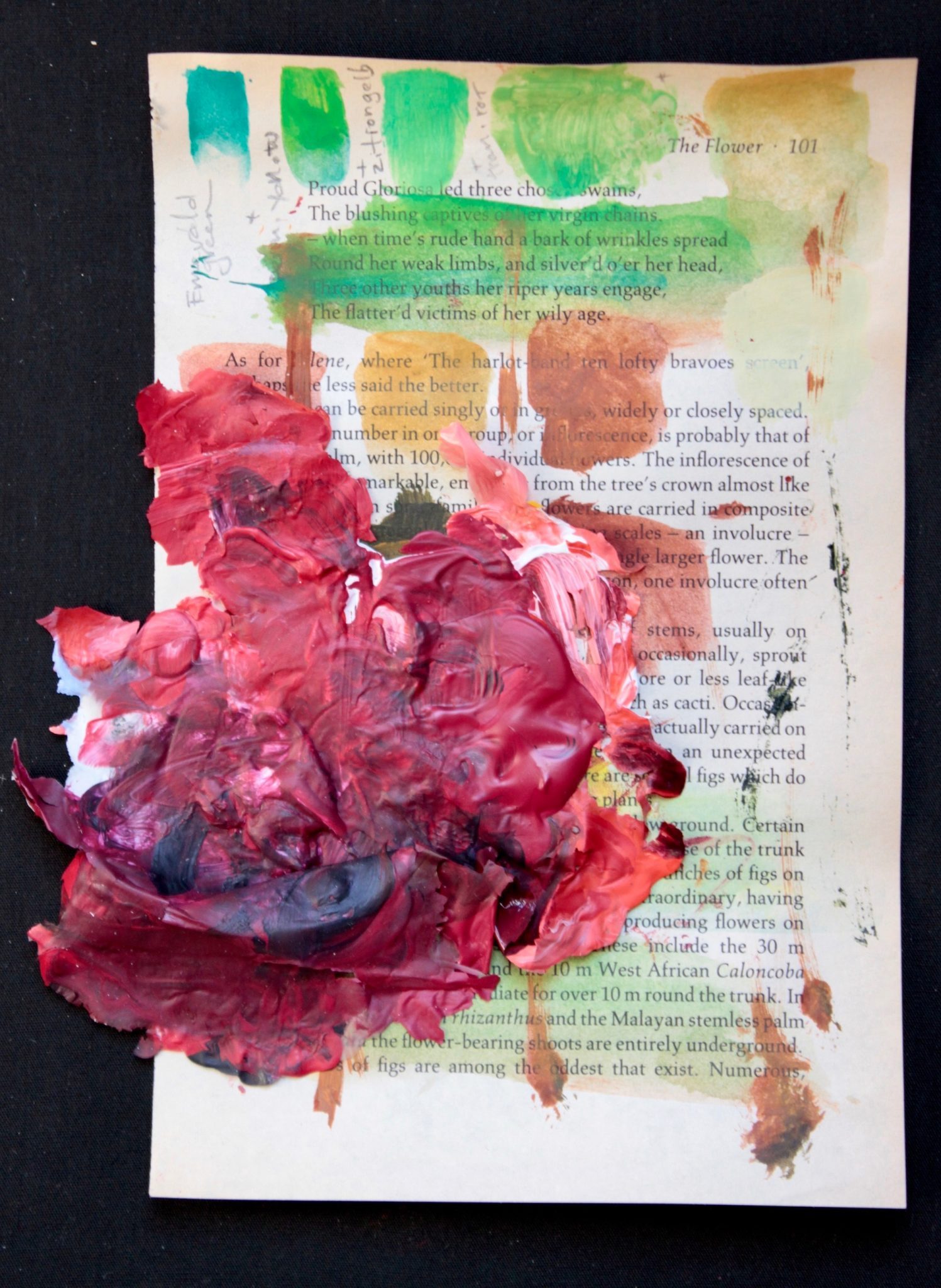 yellowed book page 101, with samples of color studies and a bright red acrylic paint 