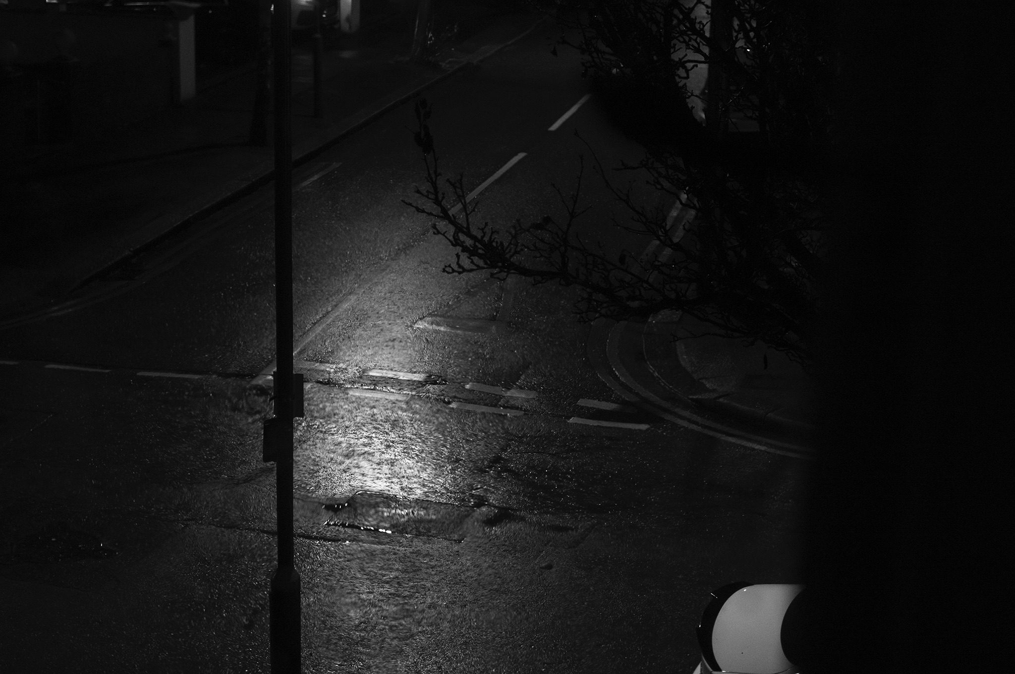 Black and White street screen of a damp street poorly lit to reflect the days them of Blindfold