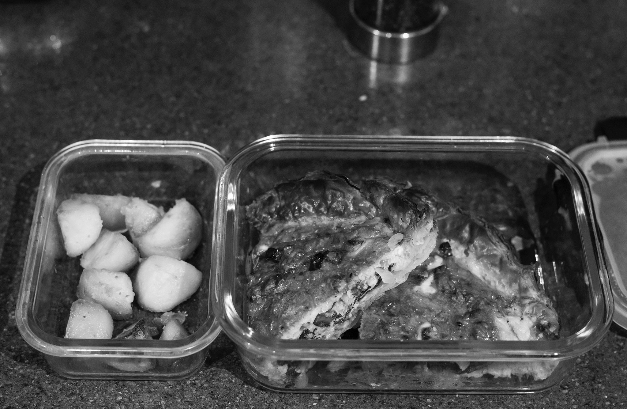 Black and White image of the left overs from diner being saved for later.