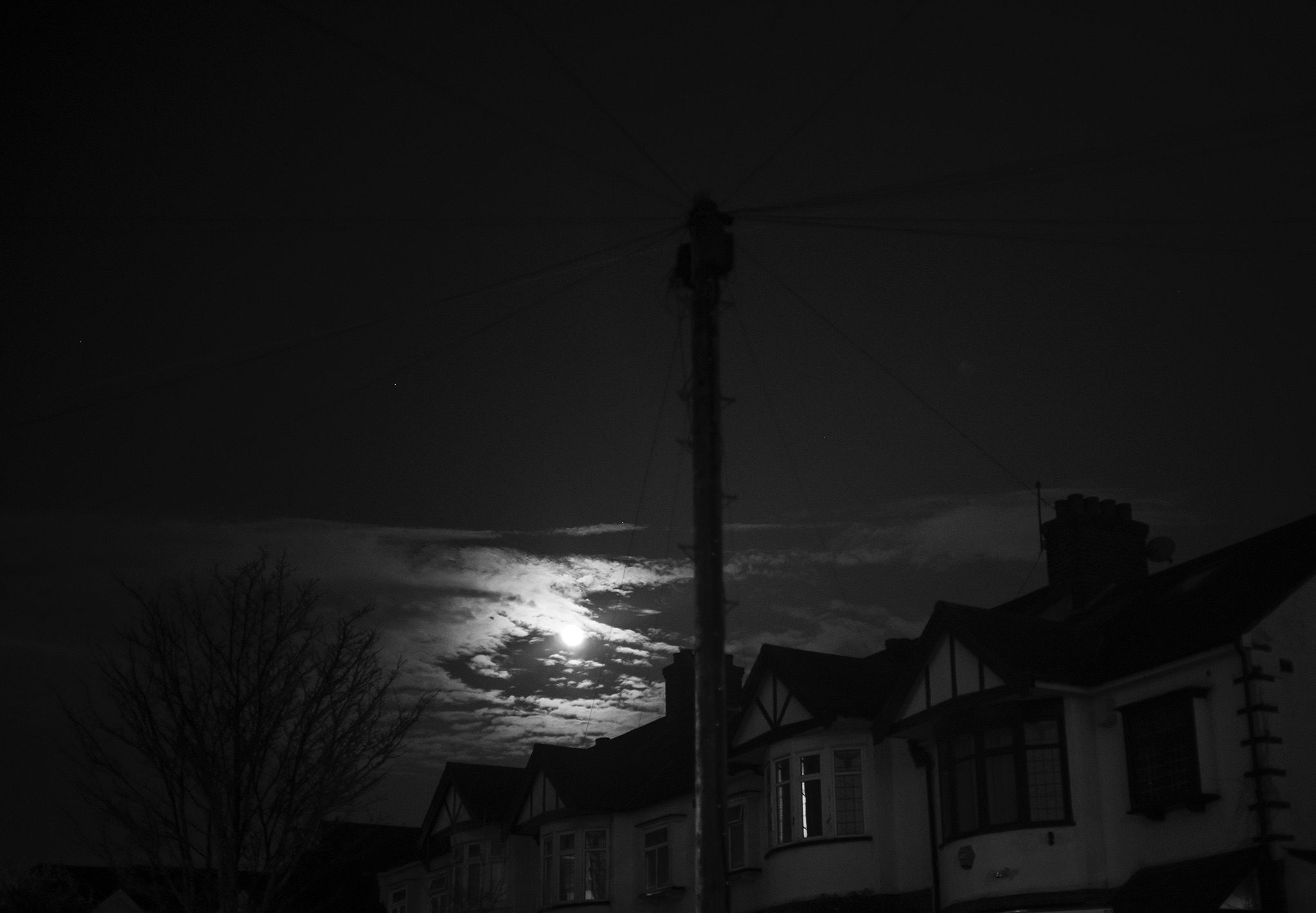 Black and White image of the moon in my street.