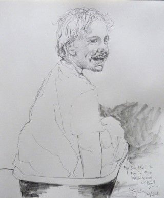 pencil drawing of a toddler sat in a washing-up bowl. Boy's back is facing viewer, with the childs head turned towards the viewer - giving a side view of his face. He's laughing.