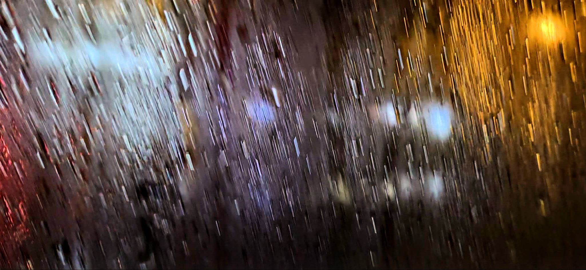 A blurred and stylised photo taken at night showing a distorted high street