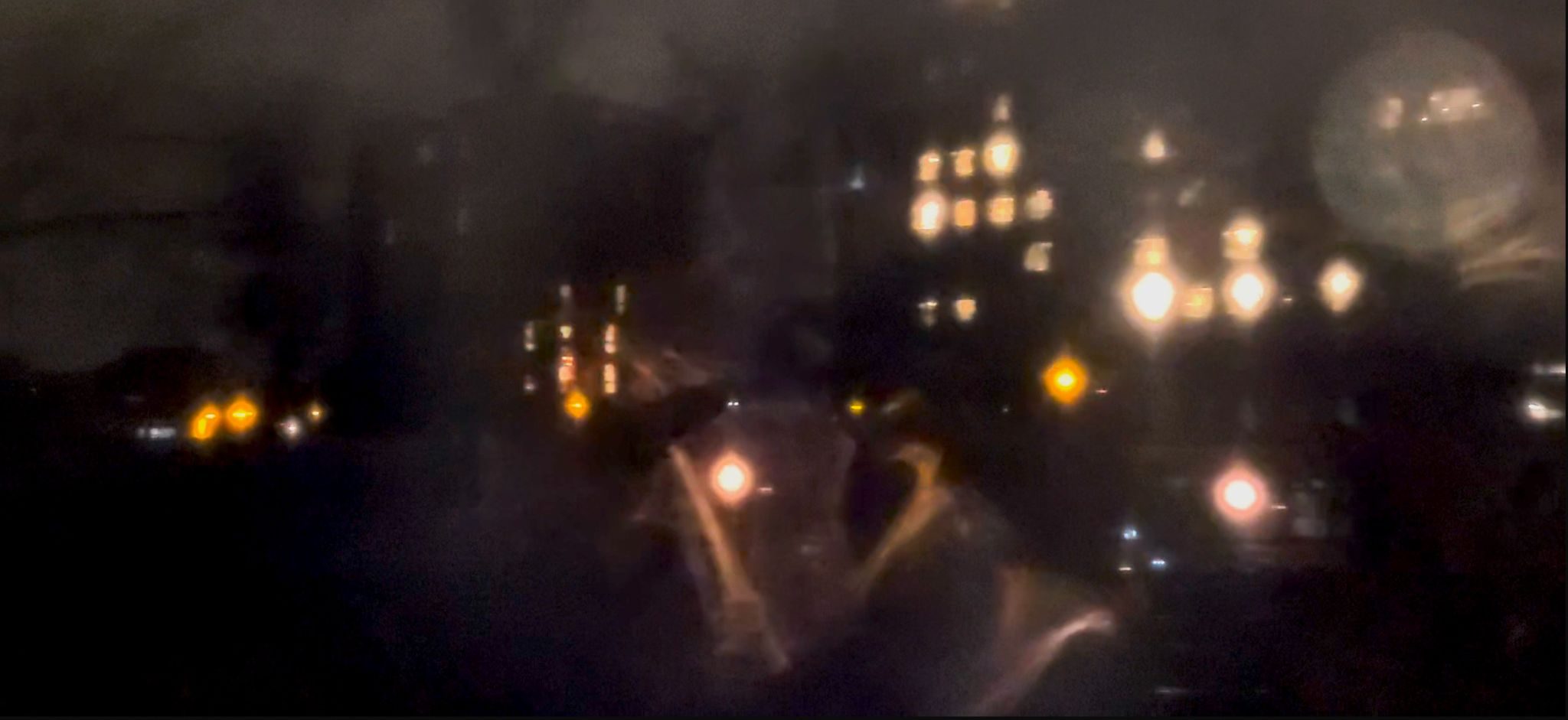 A blurred night time photo taken from a London train