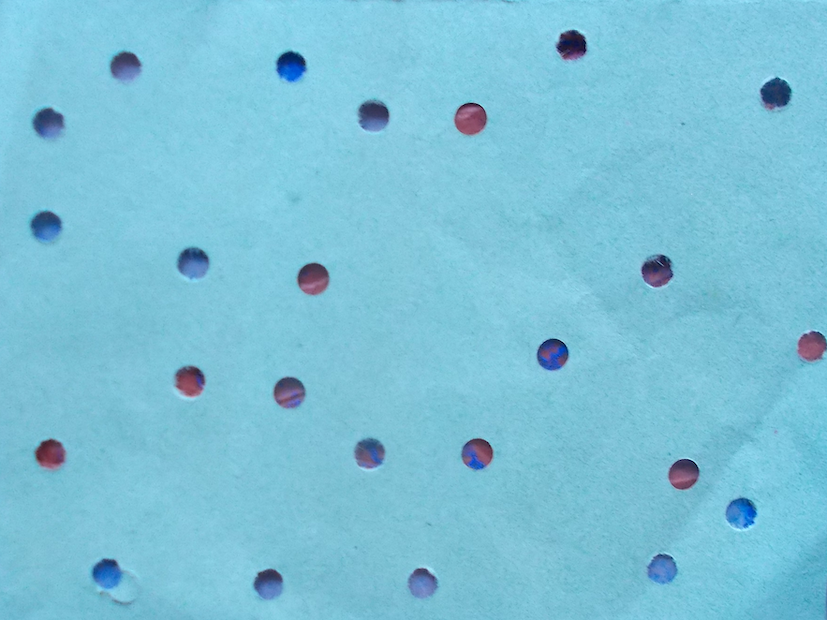 holes punched into dull green paper and placed over strong coloured ones, so slight colouring showing where the holes are
