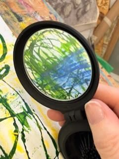 photo of part of abstract art work reflected in a small hand mirror