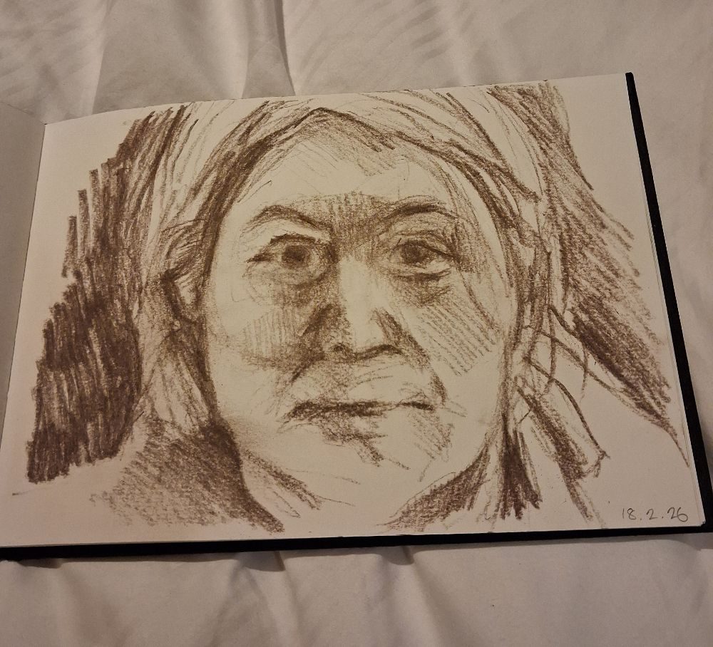 Self portrait on paper in brown conte pencil