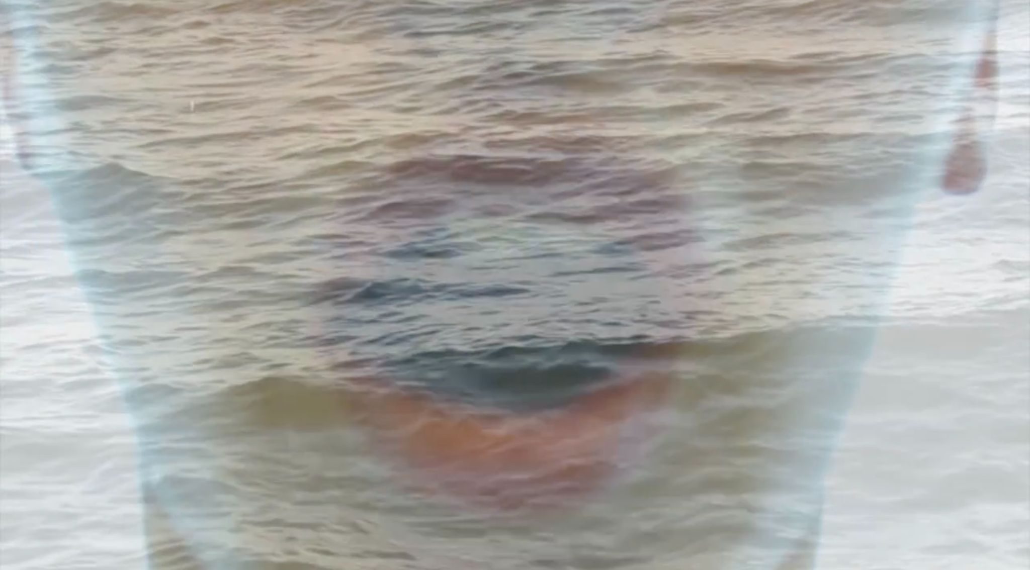The image is a screenshot from film 1 of “See, Sea” 2013.  https://vimeo.com/manage/videos/72357714 My durational installation work exploring multiplicity of ritual and image triggered by an episodic memory. Within it, a deconstruction of my swimming ritual is explored through a mixed media palette.  Within film 1, a surreal lens is created, the dancer, Irina Baldini, morphing from a domestic interior into multiple landscapes of seas, of past sensorial embodiments.  The screenshot image captures the dancer engaging in an expansive intake of breath, overlaid, submerged in the sea. The breath, a shout, a scream in reverse.