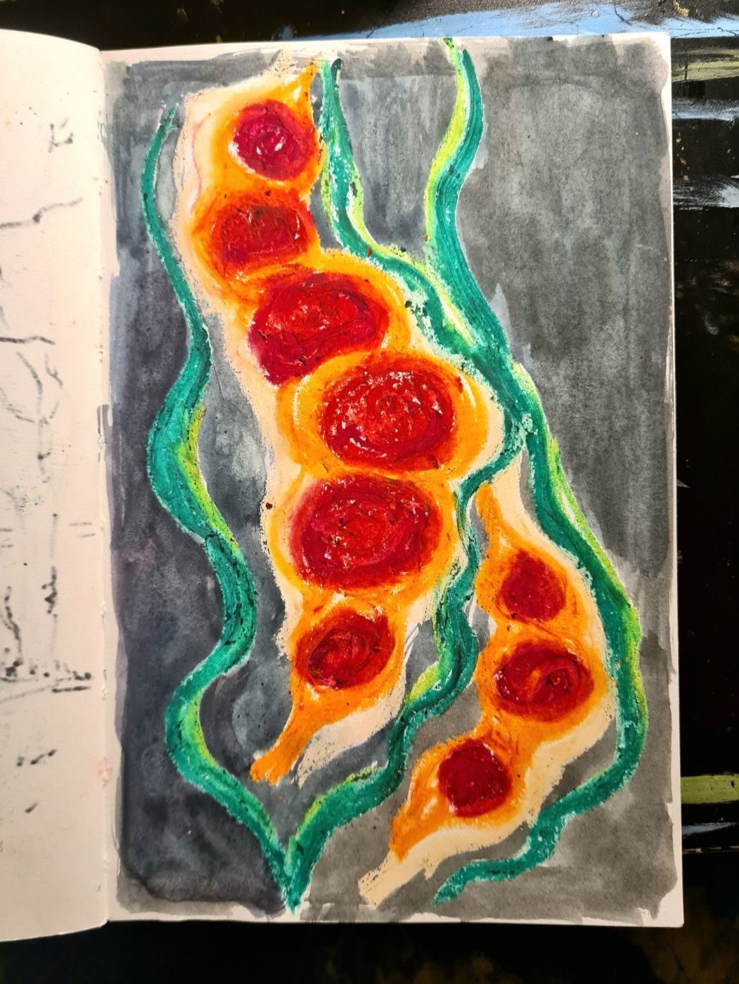 Oil pastel drawing of red and orange seed-pod like shapes with a black background
