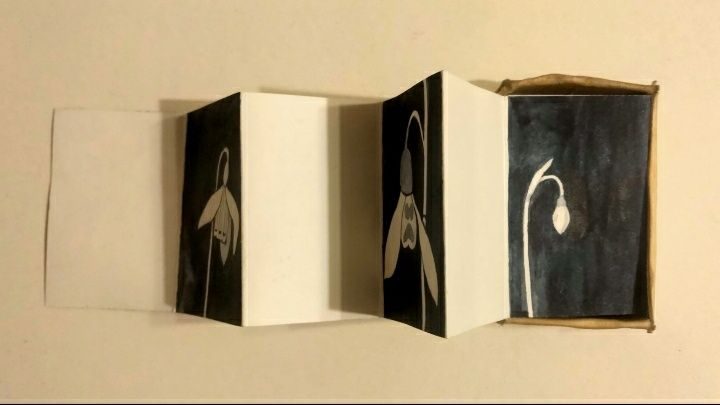 Small painting of a snowdrop, in concertina book - held inside gifted matchbox.