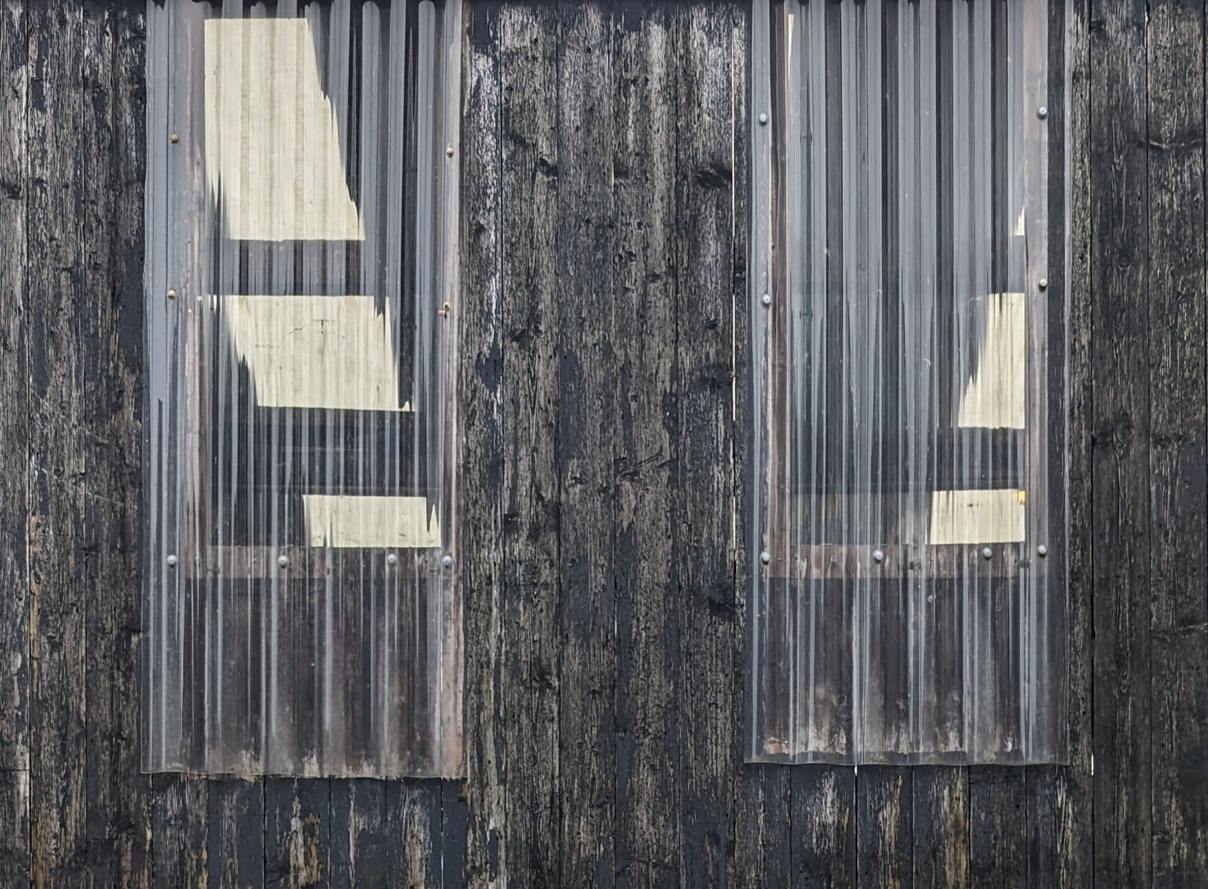 corrugated palstic windows in a shed showing light coming through the ceiling int the shed inside