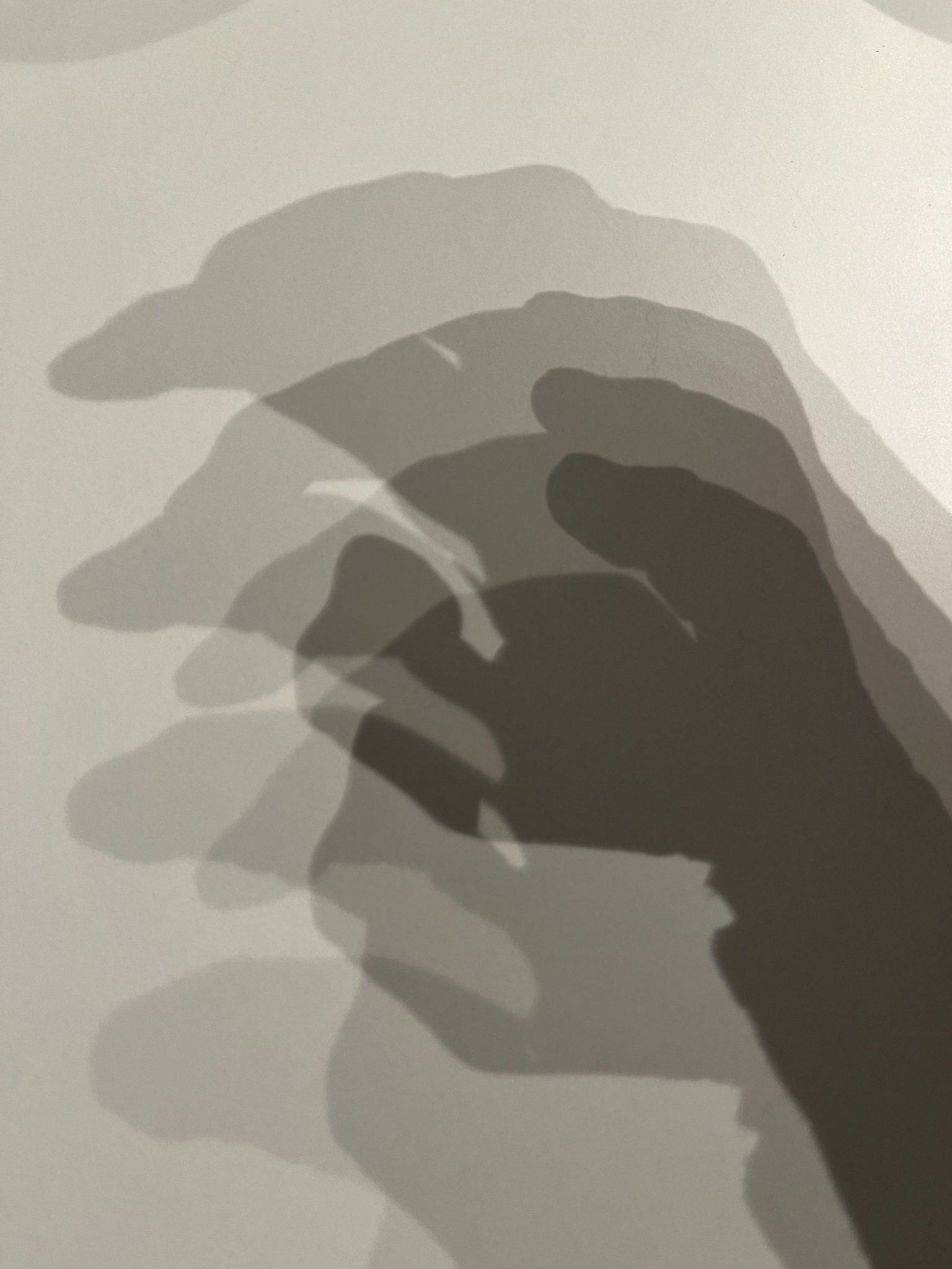 Three depths of shadow as a hand emerges
