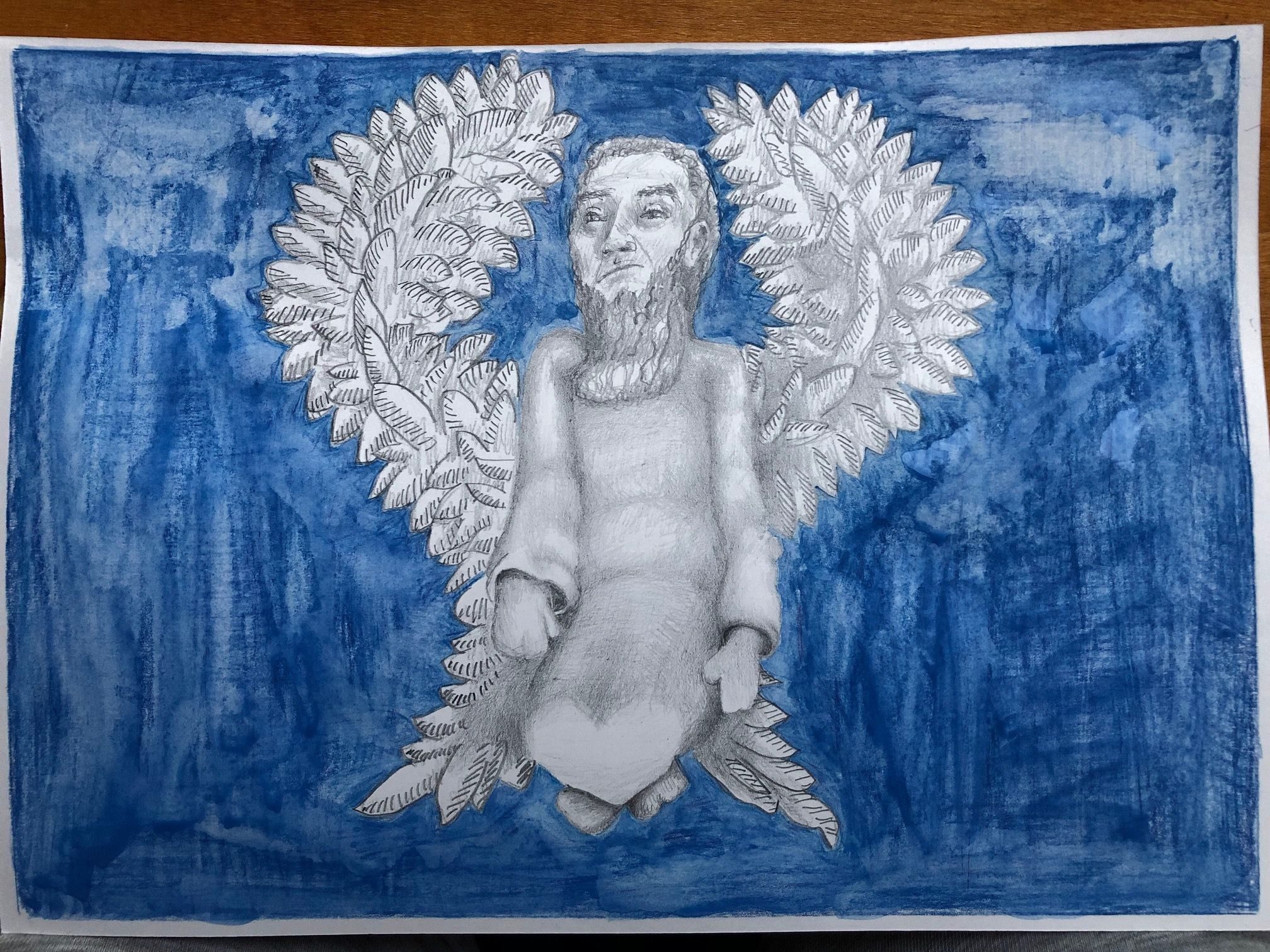 A graphite and watercolour pencil drawing on cartridge paper. The drawing is taken from a photograph of a figure I made from brown corrugated paper. The pencil sketched figure is an angel-type apparition that appears to float in a blue background; it wears a cassock and long beard, without moustache, and floats with its knees bent and feet crossed - almost a levitating angel.