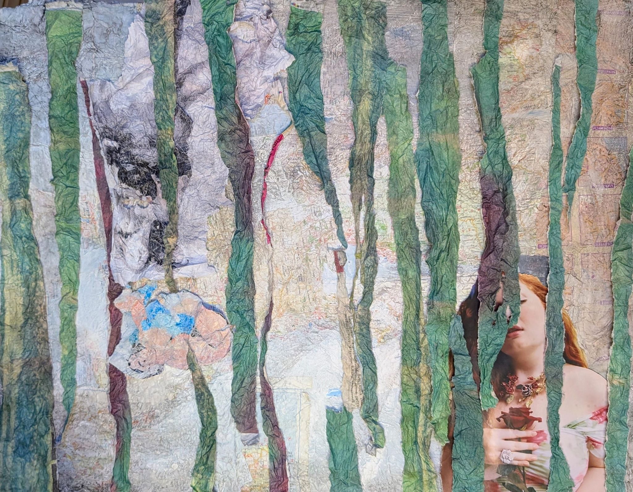 torn strips of paper hide two female figures, one of which is upside down