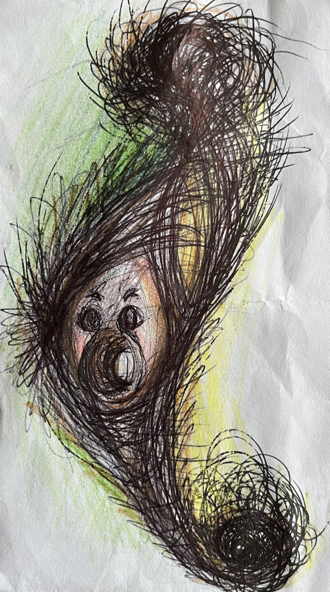 Small black biro drawing with some coloured watercolour pencil marks depicting a small face