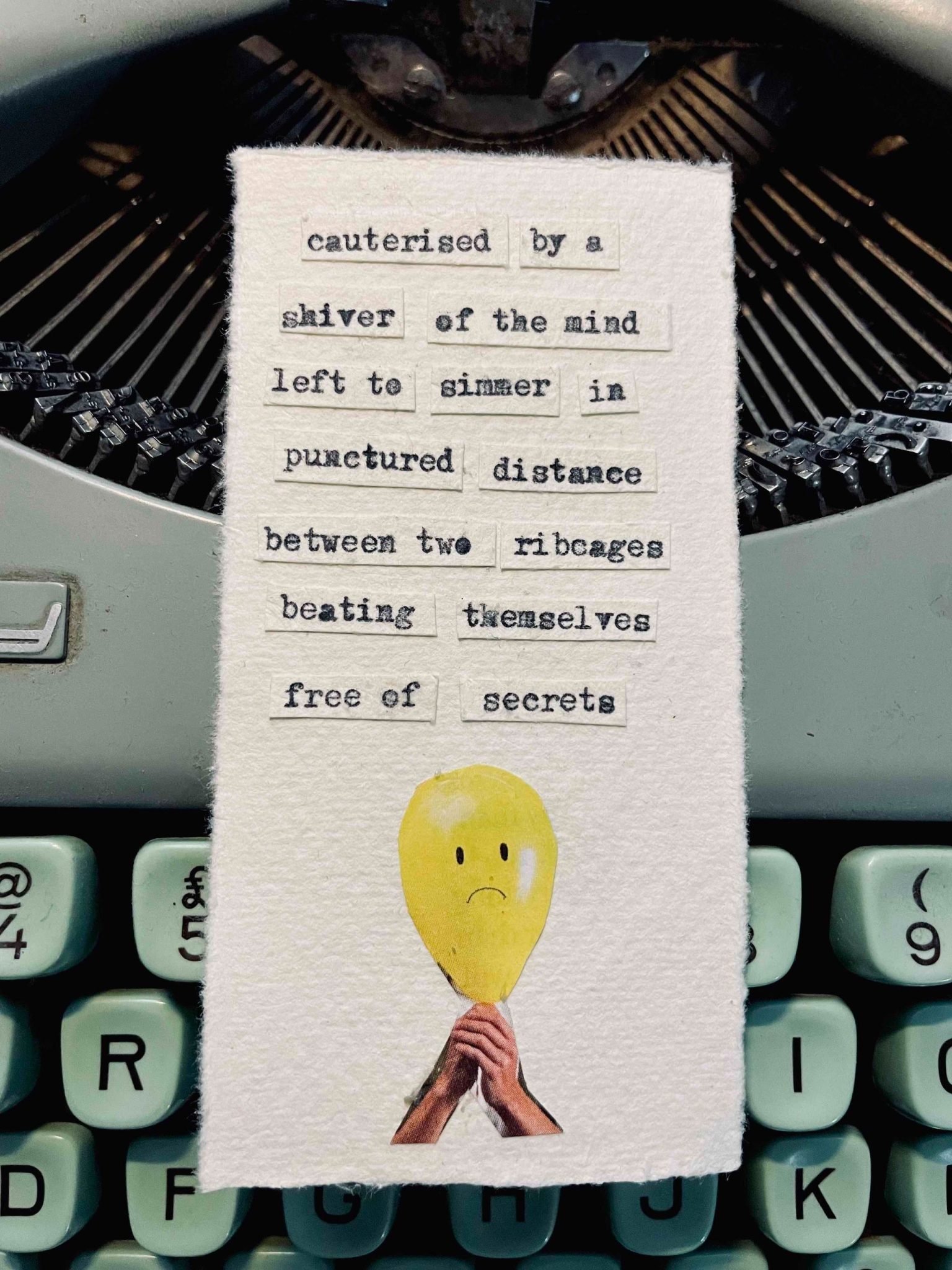 a typewriter poem and a balloon with a sadface