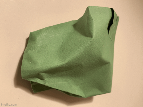 The work for today consists of two separate things. One is a green sculpture made from paper which is has been pinched and made to curve and bend in certain places and is stuck on a wall; it has also been ripped and glued together; you can see the lines on the paper which suggest the texture of what it is made from, these lines go diagonally and there are also creases here and there as well as shadows where the light doesn't fall. Then there is a postcard which is landscape orientation and seems to show a series of arching columns and a path on top of which the artist has stuck two pieces of masking tape one underneath the other parallel to each other with the writing '# one the other side of the valley' on the first bit of tape and 'one. Two. twenty-six' which is the day that the Work was made. Then there is a picture of the back of that postcard which has a website for a hostel in Prague in the top left corner, a QR code in the bottom right, and which has the following text written in black sharpie by the artist: 'cover over meaning, it is about exertion, about doing the impossible, it is about seeing what the card can do, it is not about what it looks, it is about 'does', what are your hidden rules?, I don't want it to be over, reminds me of clay'. each phrase is separated by a black line.