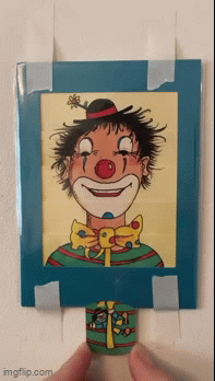 A clowun card - when the tag at the bottom is pulled the clown is happy, when it is pushed back, the clown is sad.