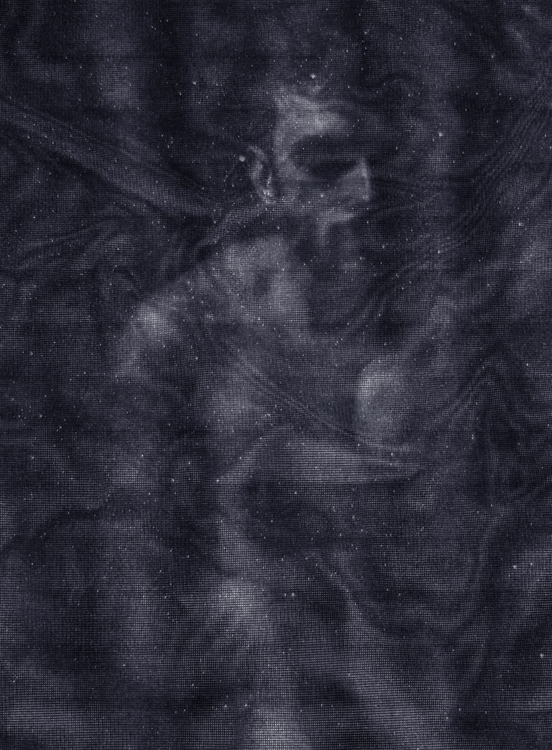 Black and white photograph of a man obscured behind swirls of netting, twinkling with starlight