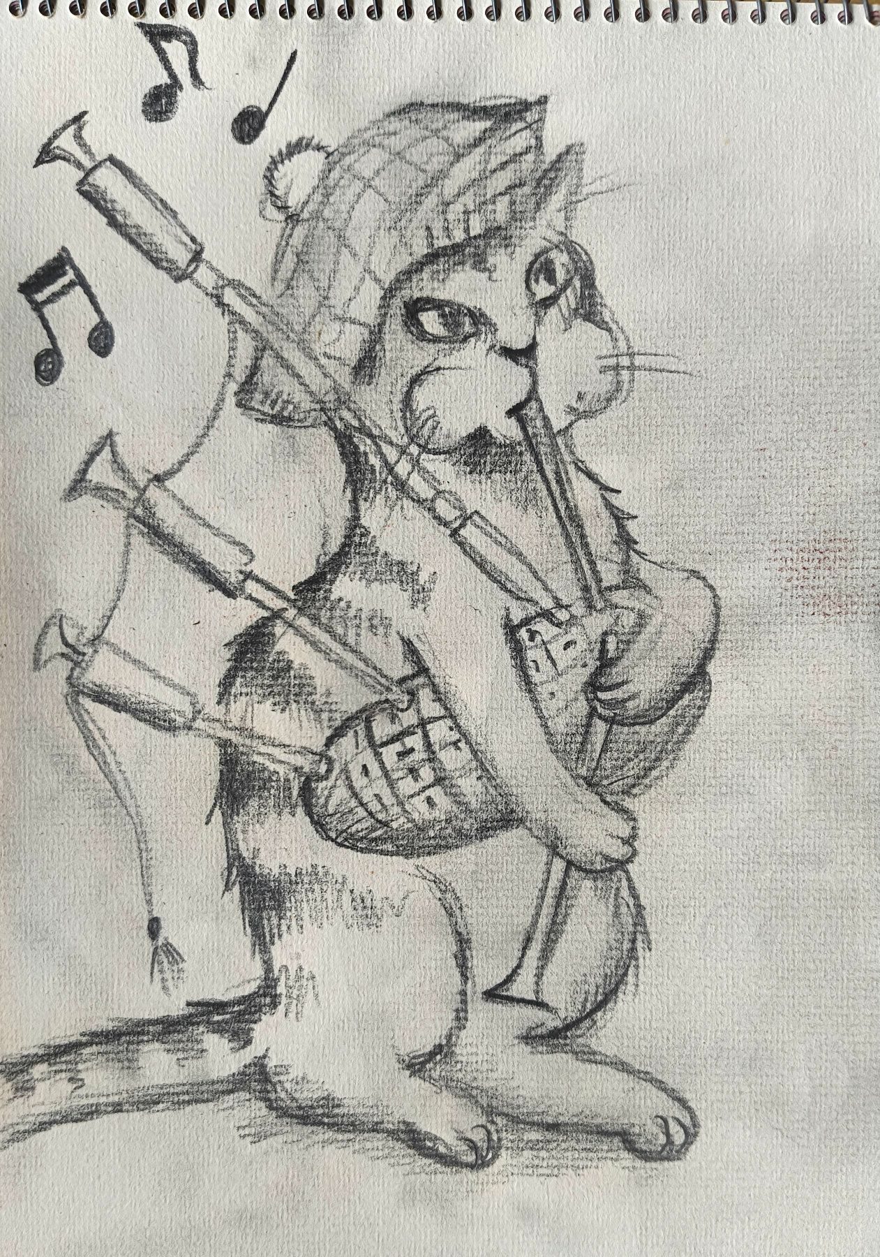A pencil drawing of a kitten playing bagpipes