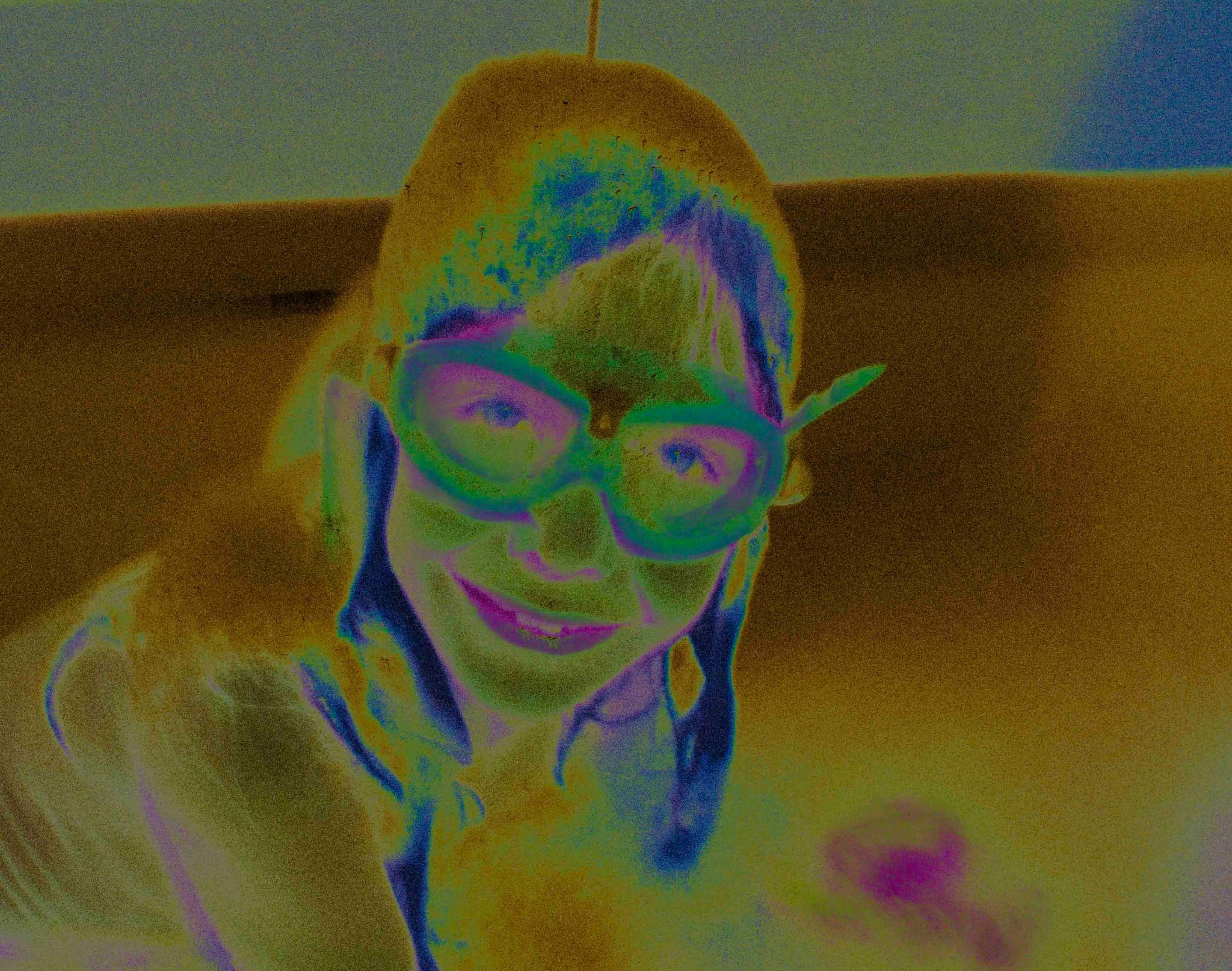 Solarised colour photograph, portrait of a girl with goggles
