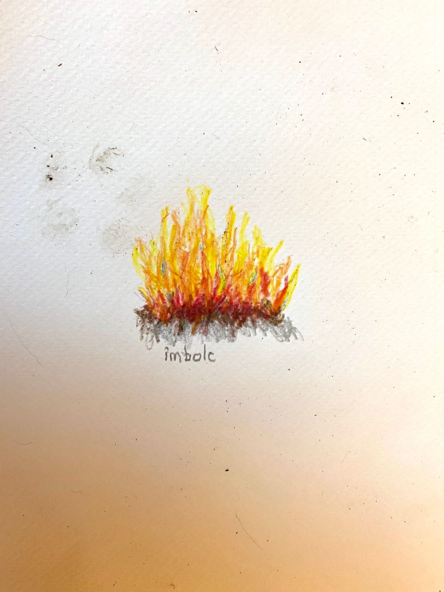 a white page with some smudges on it. In the middle of the page is a drawing of a fire in red, orange, yellow and browns. The word 