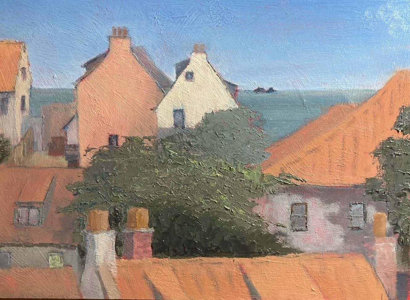 Oil painting on board, 20cm x 26.5cm. View of rooftops with the sea in the distance.