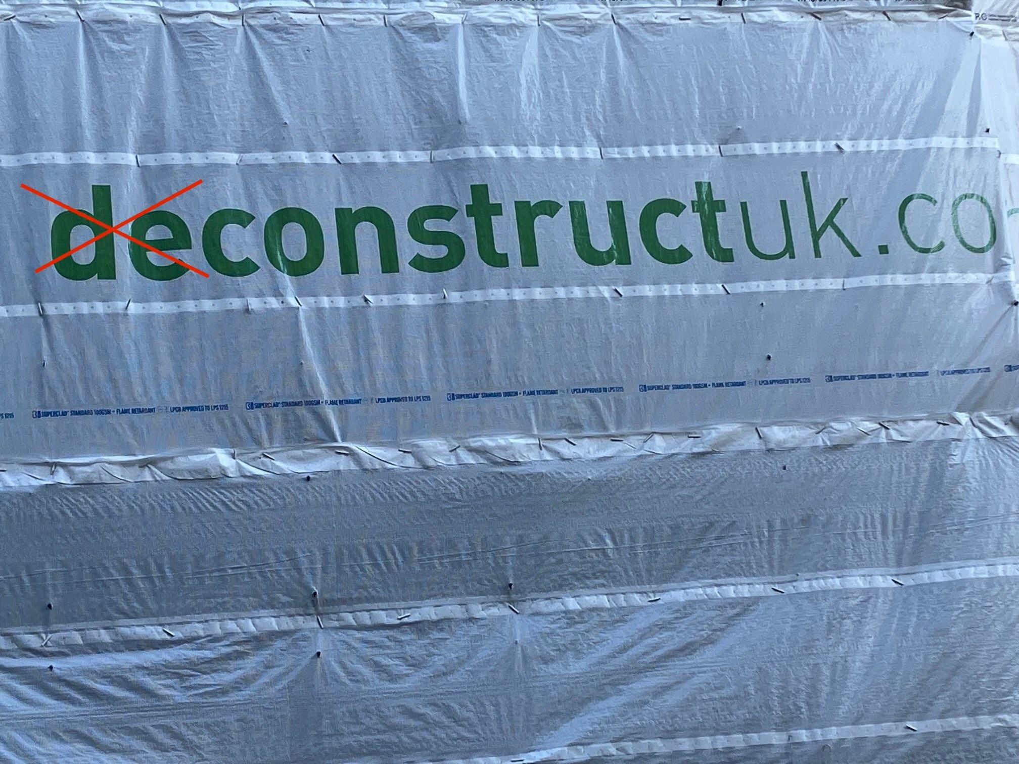 Building sign 'Deconstruct' altered to 'Construct'