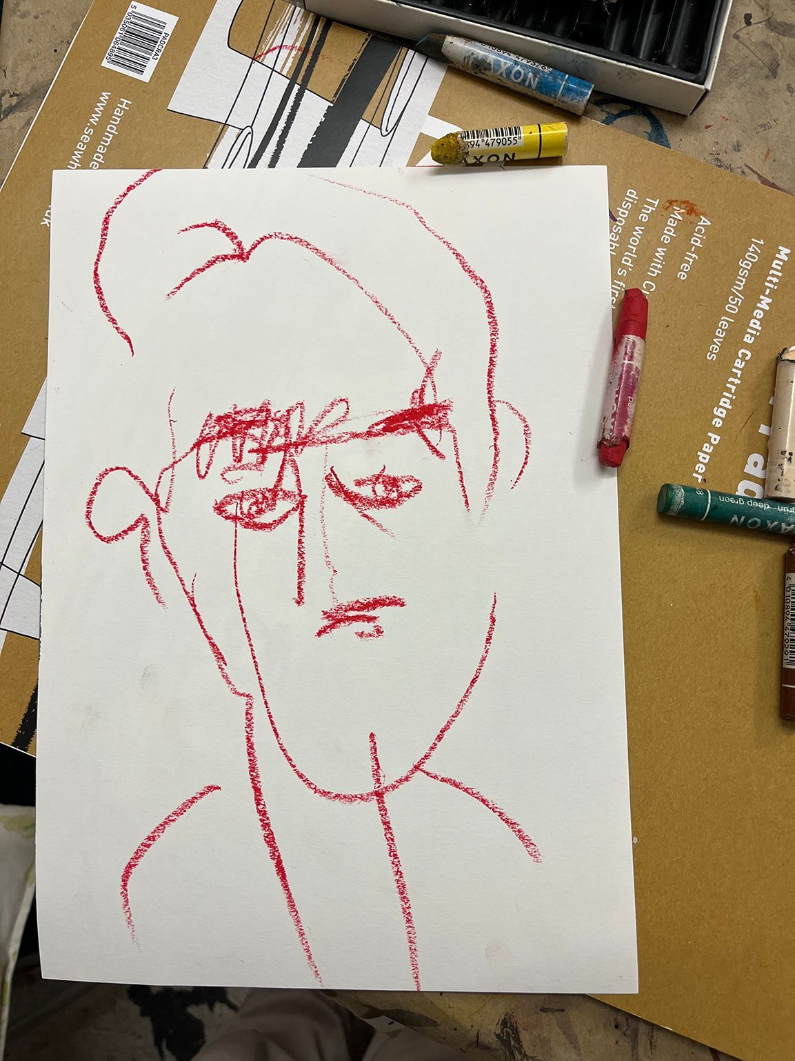 red pastel drawing of a face