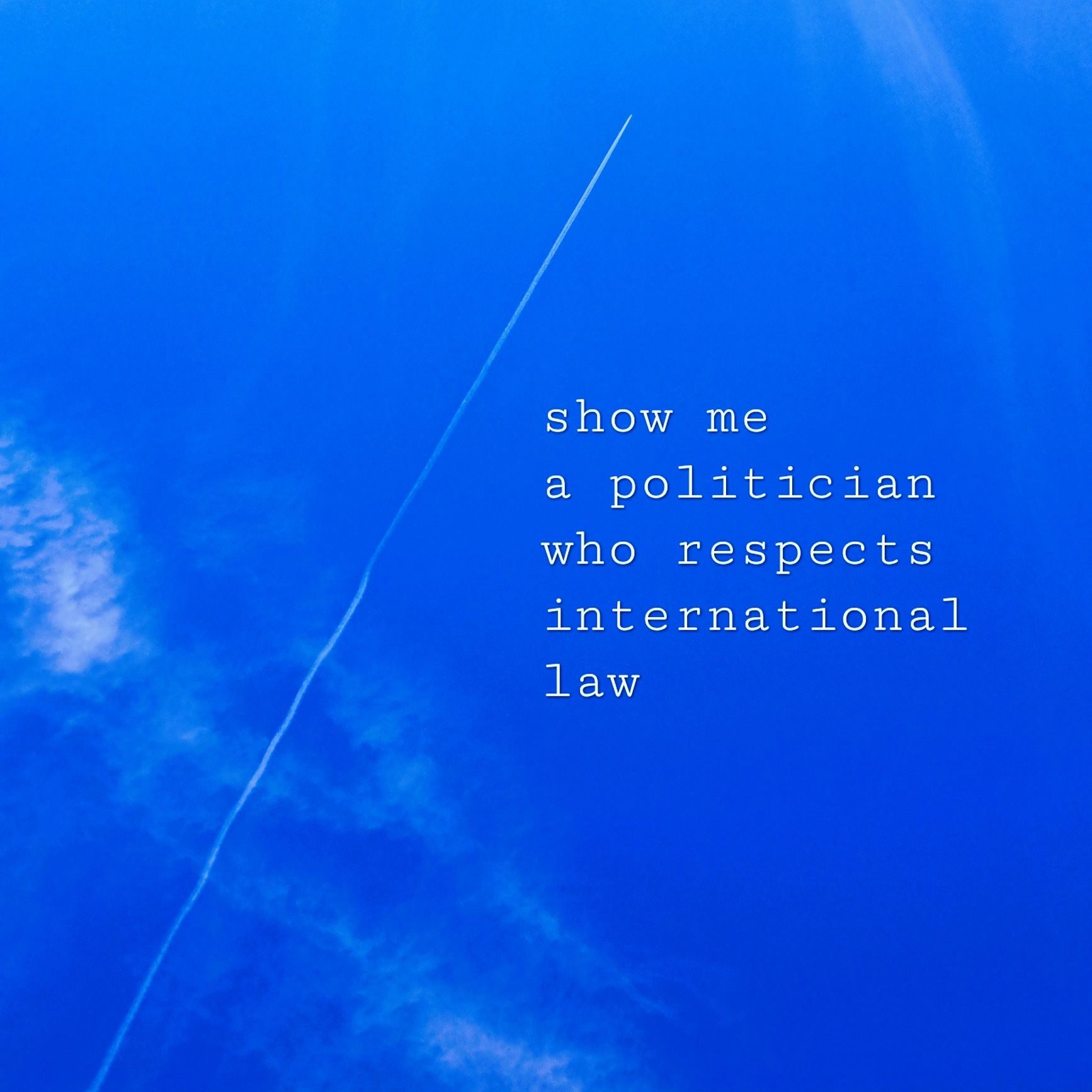 A plane trail in a blue sky and a few wispy clouds. Typewriter text on the right, it reads: 