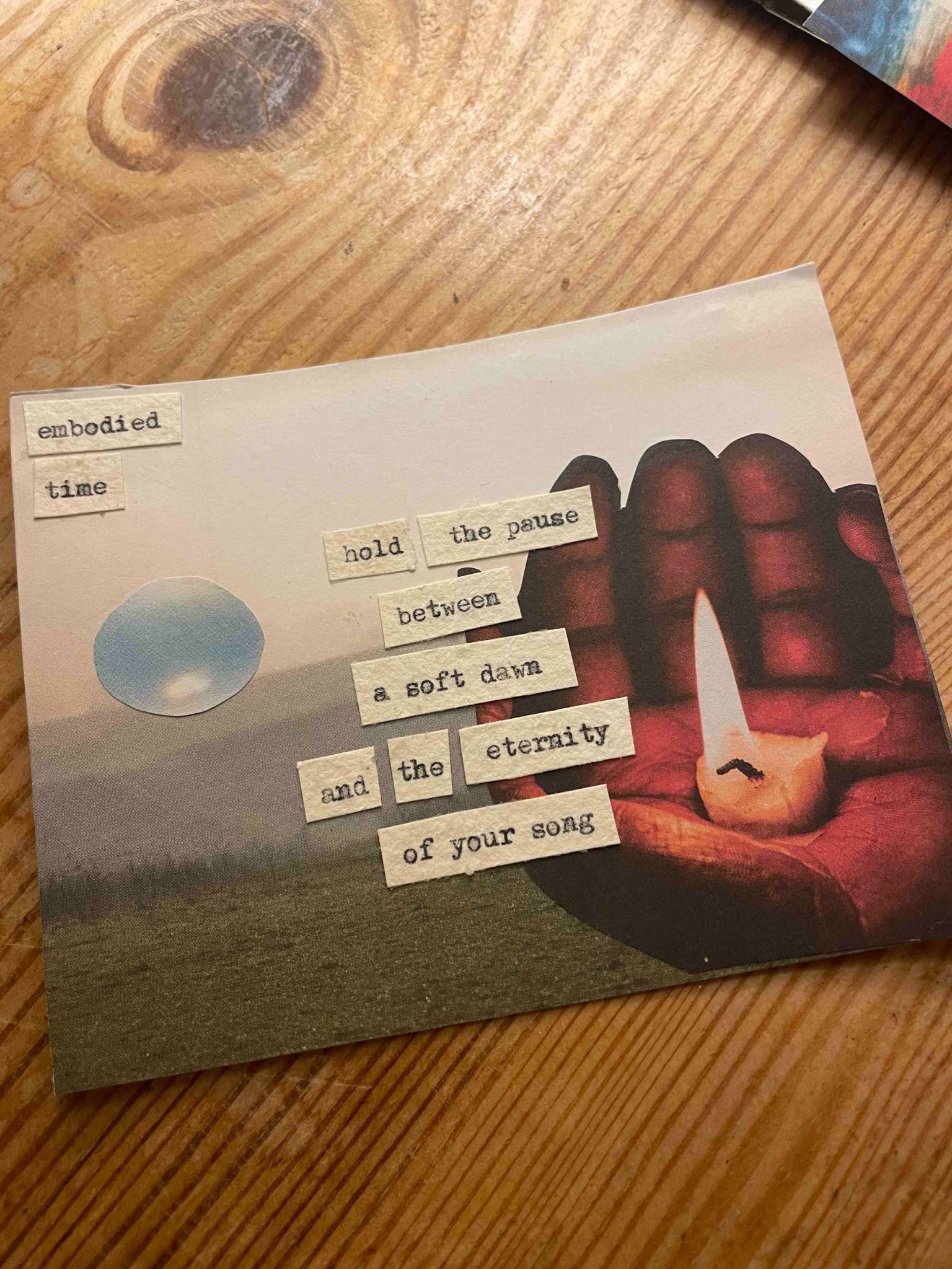 a collage of a hand with a candle in it and a type written poem