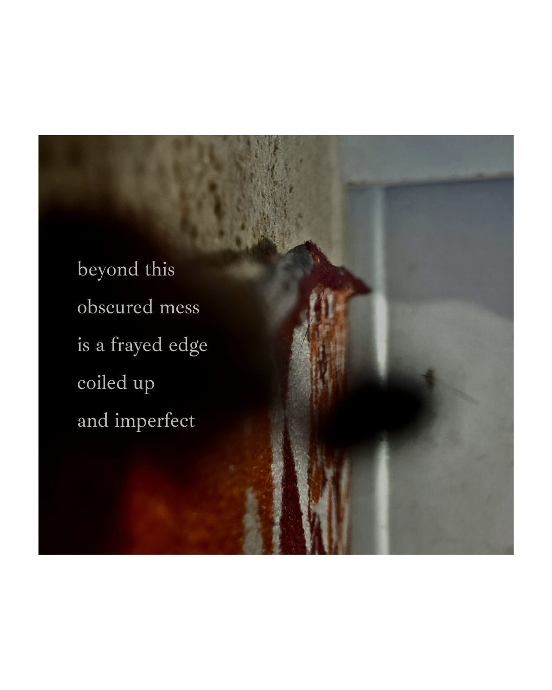 a picture of a frayed carpet with a blurry smudge of black smeared across the camera