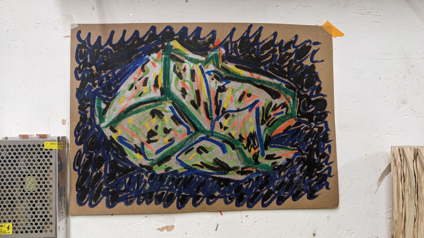 A colourful pastel drawing of a sculptural blob on sugar paper on a white gallery wall next to a metal extractor