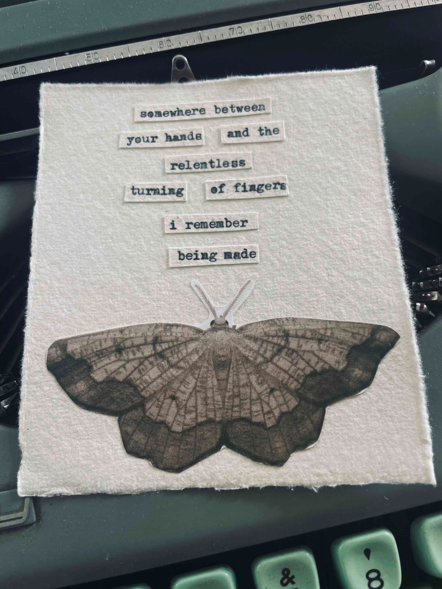 a typewritten poem stuck onto a piece of paper with an image of a moth