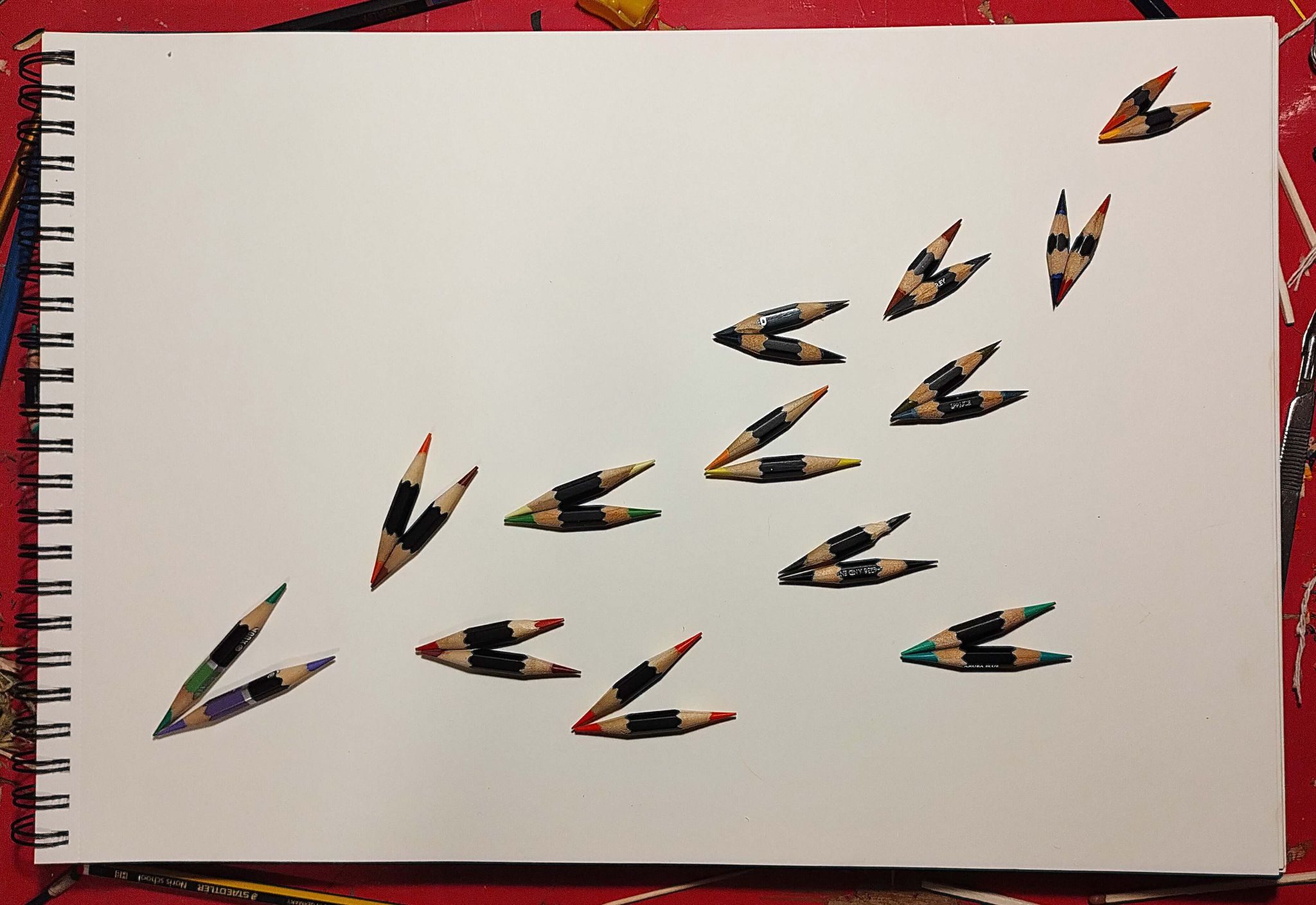 this is a small sculpture made of a cluster of tiny pencils in the form of a flock of birds