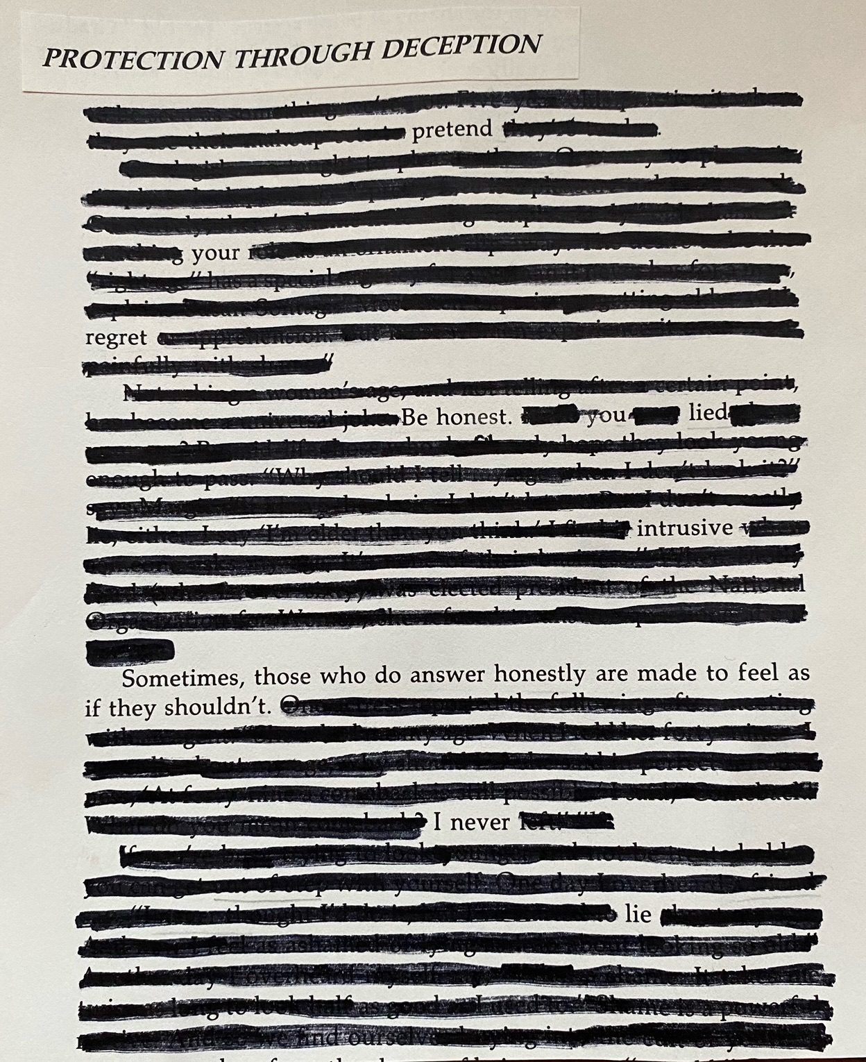 A page torn from a book with the chapter title “protection through deception”. Most of the words are blacked out with a marker pen except for “pretend … your … regret … Be honest … you …. lied … intrusive … Sometimes, those who do answer honestly are made to feel as if they shouldn’t. … I never … lie”