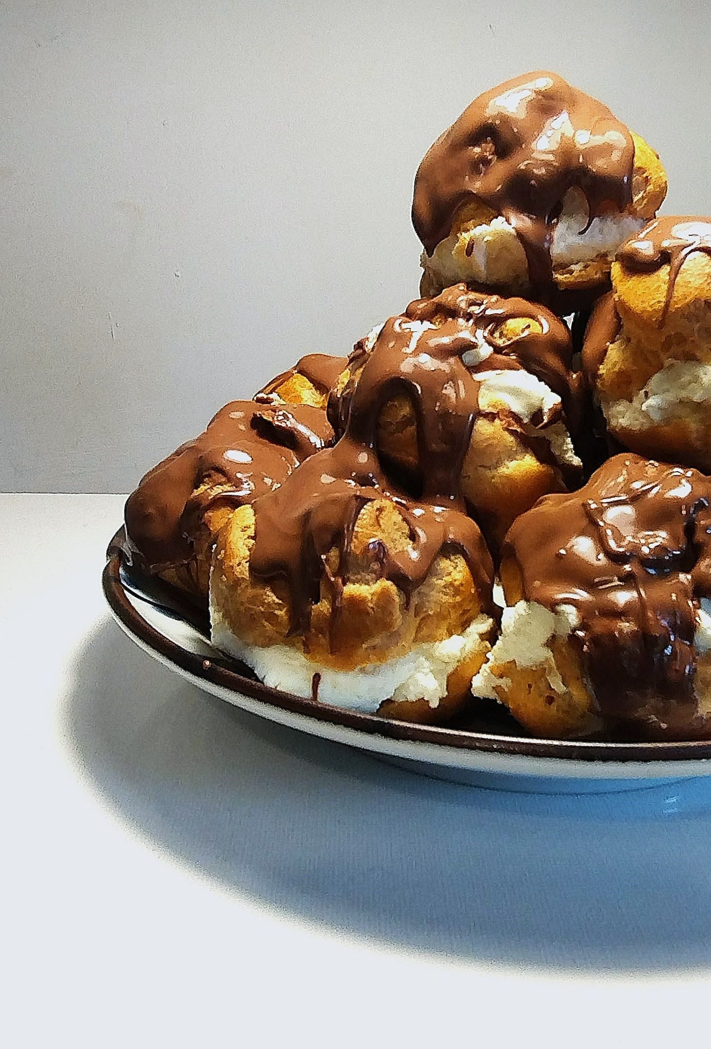 this is a photograph of a bowl of Profiteroles, showing only the left hand side of the image